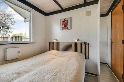a bedroom with a bed in a room with a window at C11704-Hemmet-Rylevaenget-33 in Hemmet
