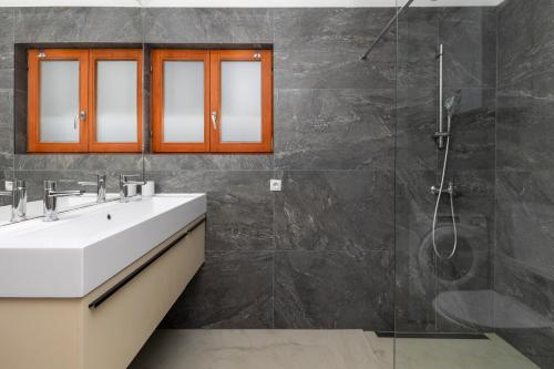 a bathroom with a sink and a shower at House Serenity in Njivice