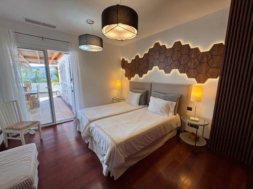 a bedroom with a large bed with a wooden headboard at Villa Dedalos - Spacious luxury Villa with heated pool in Puerto Calero in Puerto Calero