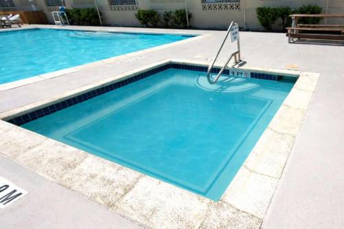 a swimming pool with blue water at EZ Beach Access Great Family Condo SpaceX view in South Padre Island