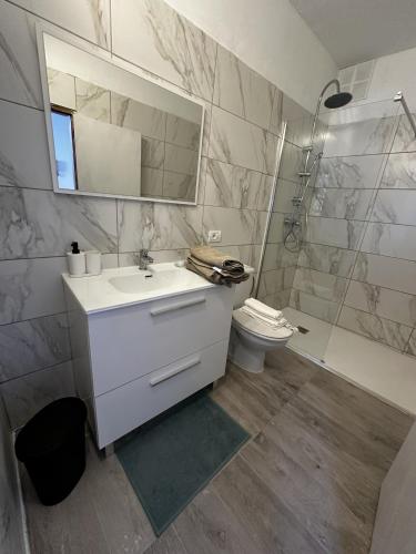 a bathroom with a sink and a toilet and a mirror at Modern & Comfortable Apartment in Tenerife South in Guargacho