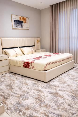 a bedroom with a large bed in a room at Lovely Residence in Al Khobar