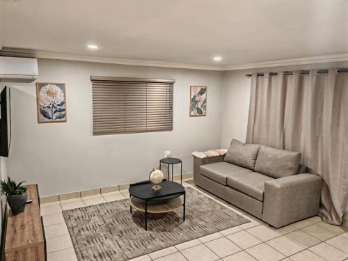 a living room with a couch and a table at 18 on Asbestos in Nelspruit