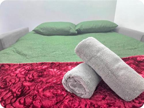 a bed with two towels on top of it at Double Room with attach Bathroom in London