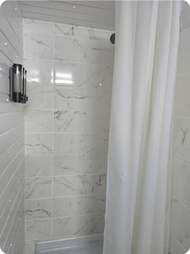 a white shower with a curtain in a bathroom at Double Room with attach Bathroom in London