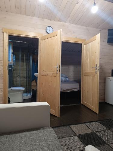 a room with a bathroom with a toilet and a clock at domik in Lapmežciems