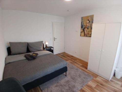 a bedroom with a bed and a white closet at City Hub Room 22 - mit Balkon - Coffee for free - in Karlsruhe