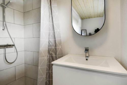 a white bathroom with a sink and a mirror at C11348-Tarm-Laksestien-3 in Tarm