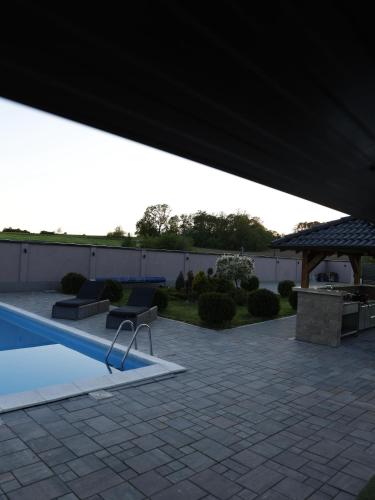a patio with a pool and a gazebo at Muzzle House in Knić