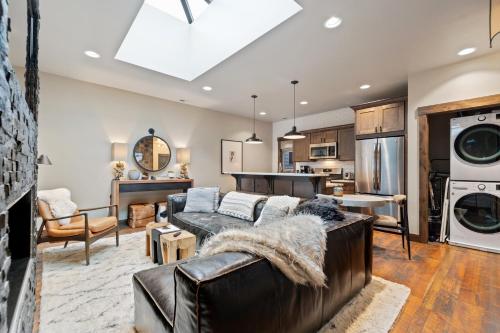 a living room with a couch and a kitchen at Central Loft 303 in Whitefish