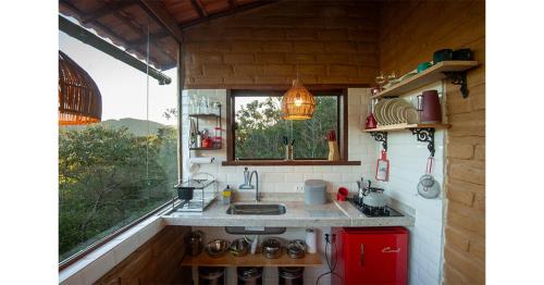 a small kitchen with a sink and a window at Lilás Hospedagem e Terapias in Vale do Capao