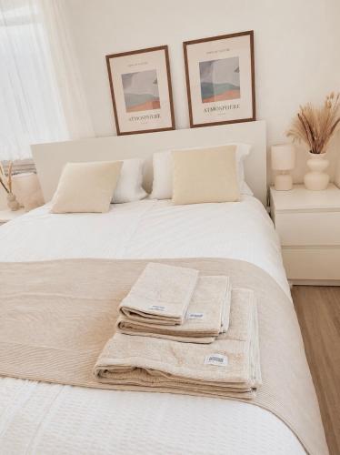 a bedroom with a bed with towels on it at STAY - Comfort Apartment in Friedrichshafen
