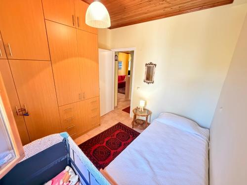 a small room with a bed and a hallway at Like a local in Chios Castle in Chios