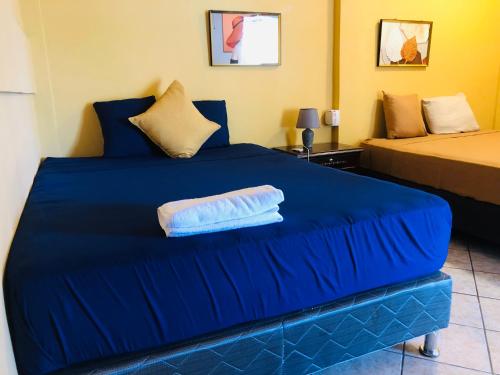 a blue bed with a towel on top of it at Terra Vista Hotel in El Guayabo