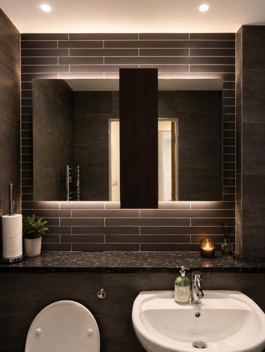a bathroom with a sink and a mirror at One bed apartment - City Centre in Manchester