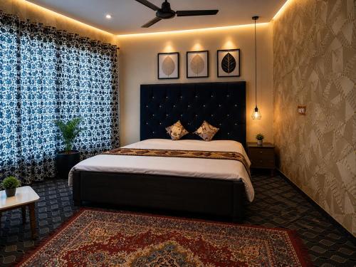a bedroom with a large bed with a black headboard at Younis Guest house in Srinagar