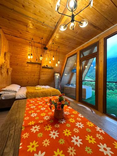 a bedroom with a large bed with a red rug at cottage sunrise house merisi in Merisi