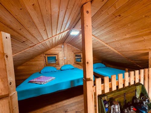 a room with two beds in a wooden cabin at Vikendica Eldar, Ada Bojana in Ulcinj
