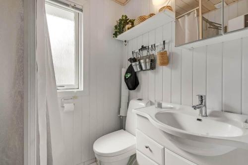 a white bathroom with a toilet and a sink at C11712-Bork-Havn-Magevaenget-17 in Falen