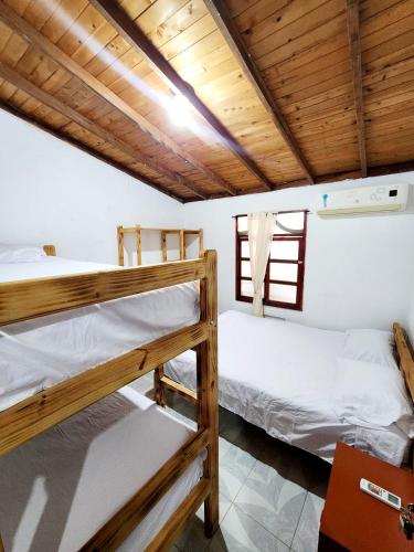 two bunk beds in a room with wooden ceilings at Cabaña Florez in Santa Marta