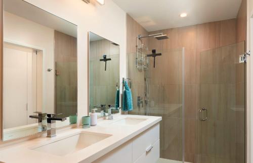 a bathroom with a sink and a shower at Modern 2BR Beachside Haven Ground Floor and Pool in Saint Peter