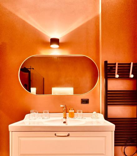a bathroom with a sink and a mirror at Le Palm House has two bedrooms with the breathtaking view over lake Como in Perledo