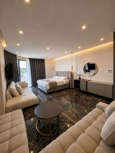 a hotel room with a bed and a couch at Grand Clochē in Ulcinj