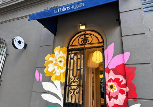 a store front with a door with flowers on it at Los Patios de Julia by DOT Boutique in Buenos Aires