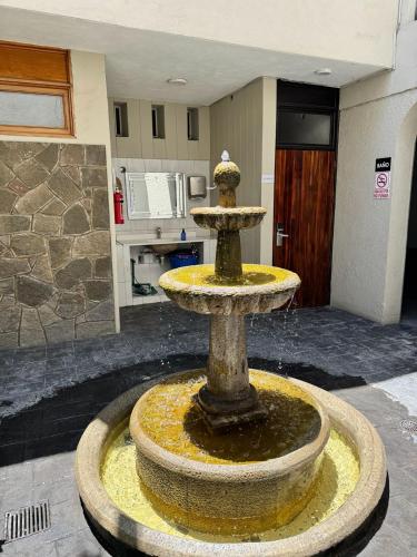a water fountain in the middle of a room at HOTEL FLAMINGOS DE CIUDAD GUZMAN in Ciudad Guzmán