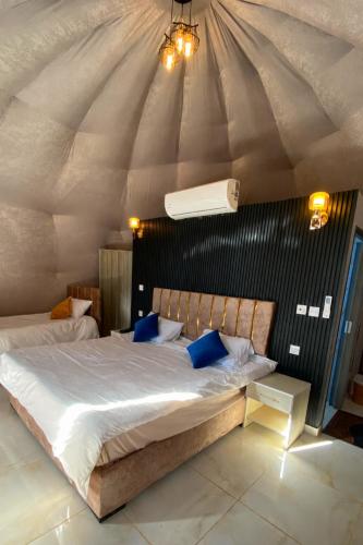 a bedroom with a large bed in a tent at Olivia Rum Luxury Bubbles & Jeep Tours in Wadi Rum