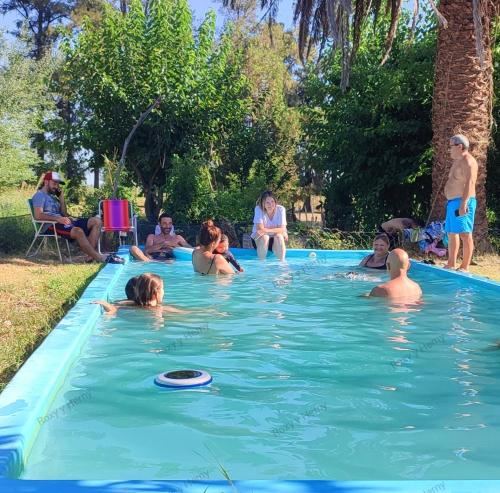 a group of people playing in a swimming pool at La Elegida Villars in General Las Heras