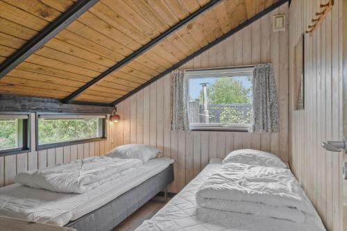 a bedroom with two beds and a window at 40572-Juelsminde-Pot-Strandby-134 in Sønderby