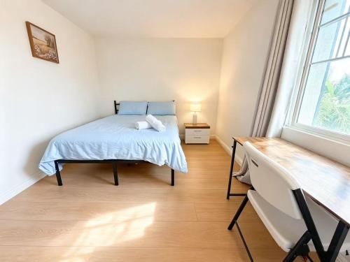a bedroom with a bed and a window at Spacious Private Bedrooms With Full Amenities Near Grocery Stores & Main Highway Routes in Fontana