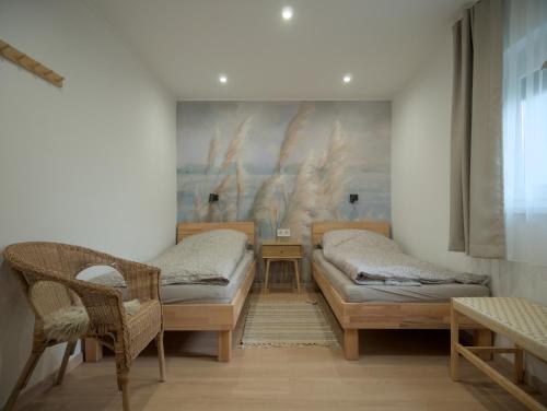 a room with two beds and a table and chairs at Vadvirág Villa in Soltvadkert