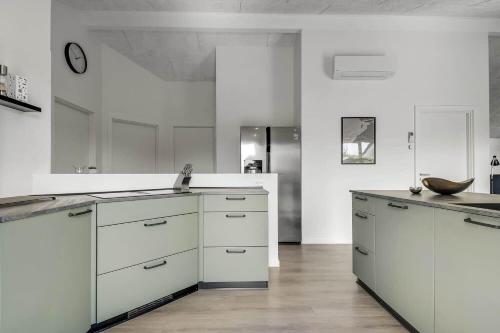 a white kitchen with white cabinets and a sink at C11349-Tarm-Stikkelsbaervej-43 in Tarm