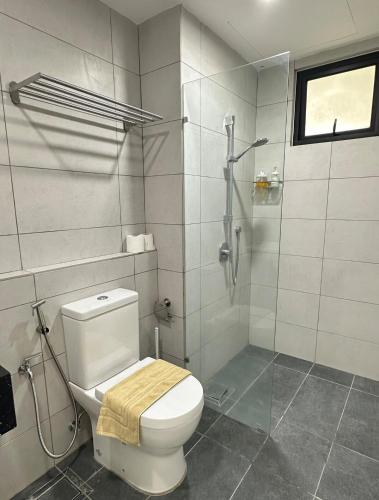 a bathroom with a white toilet and a shower at Studio 4pax SunshineKekloksiView in Ayer Itam