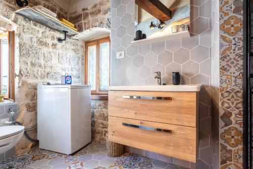 a bathroom with a sink and a toilet at House Morski brk in Trogir