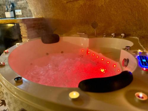 a bath tub filled with red water in a bathroom at Loft La Cueva del Niño in Vejer de la Frontera