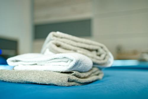 a pile of towels sitting on top of a bed at La Locanda del Gusto in Cadro