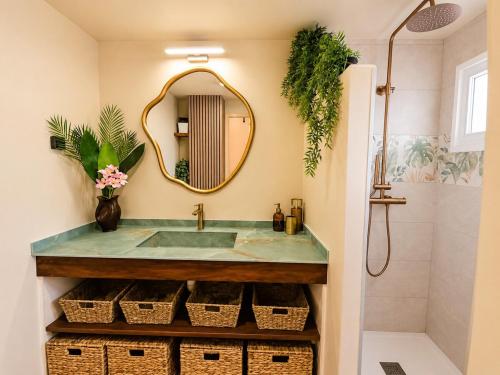a bathroom with a sink and a mirror at Tropical Chic Studio - Marina View - Swimming Pool in Les Trois-Îlets
