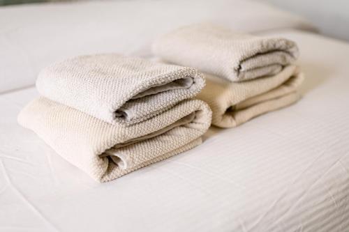 a stack of towels sitting on a bed at Holiday Home in Komarna