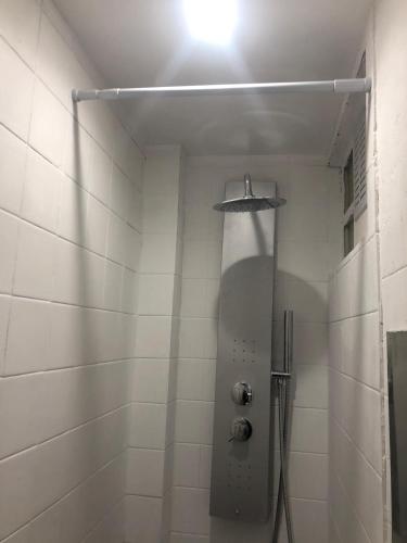 a bathroom with a shower with a light on the ceiling at Near Paris in Ris-Orangis