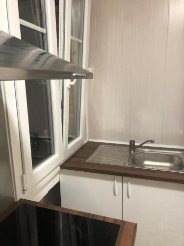 a kitchen with a sink and a window at Near Paris in Ris-Orangis