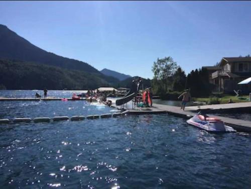 a group of people on a river with a boat at Lake Sutherland Chalet Tiny home with lake access in Port Angeles