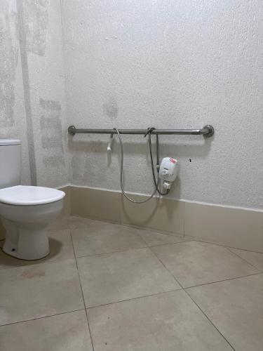 a bathroom with a toilet and a shower at Hotel Via Center in Divino