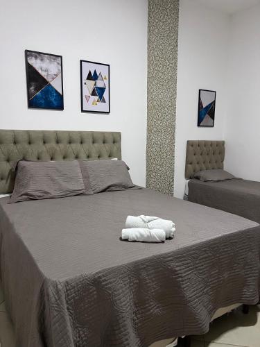 a bedroom with a bed with two towels on it at Hotel Via Center in Divino