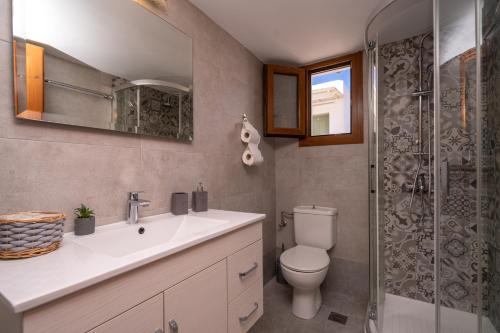 a bathroom with a toilet and a sink and a shower at Flo Guest House in Sifnos