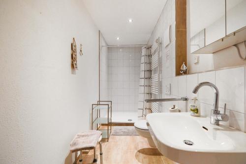a white bathroom with a sink and a toilet at Landhof Riehlingshöhe in Kißlegg