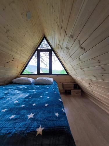 a large bed in a room with a large window at Villetta Sioni in Sioni