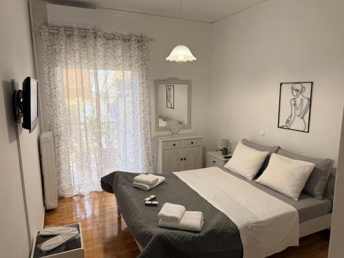 a bedroom with a bed with two towels on it at KATERINA's House in Preveza